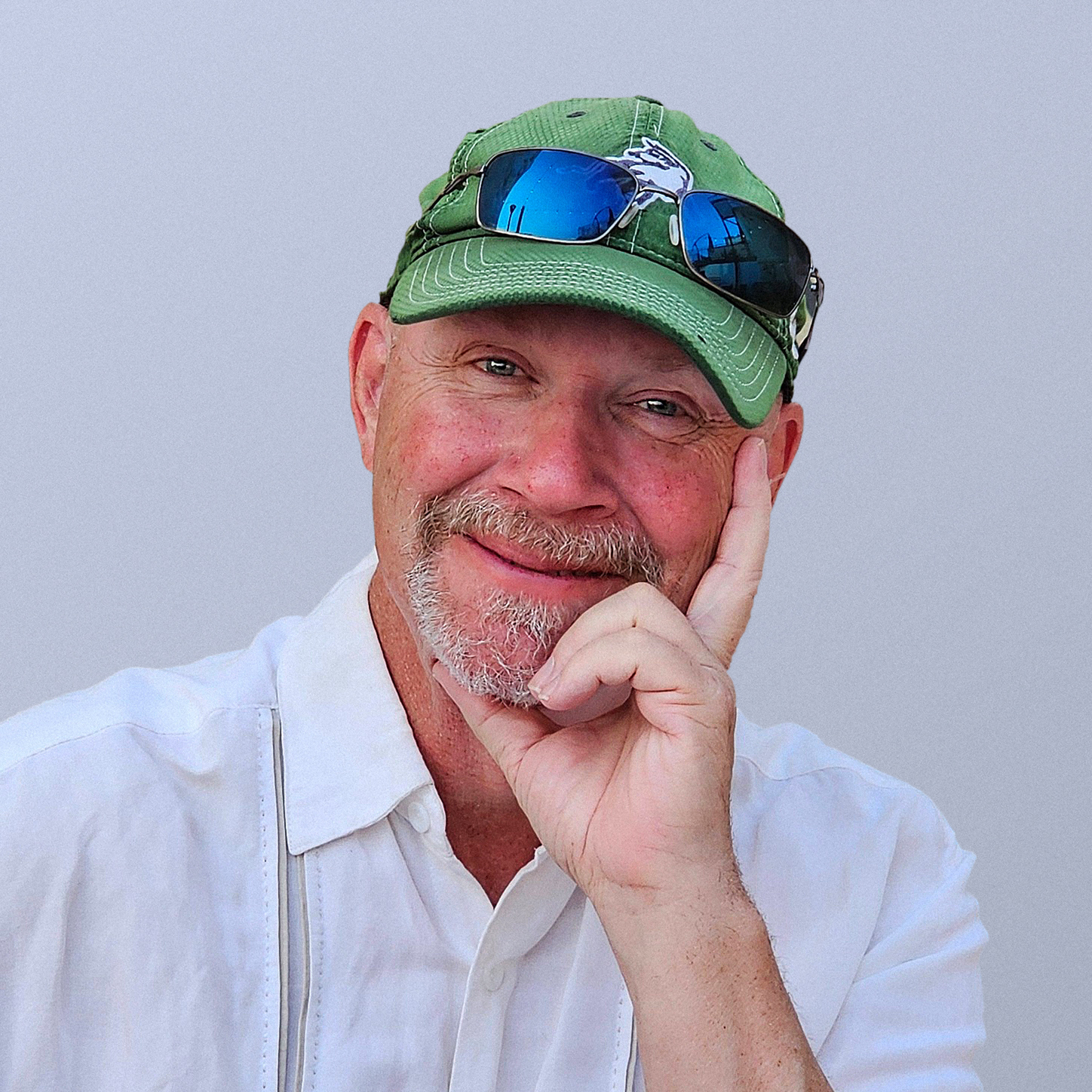 Photo of Steve wearing his favorite green cap and classic wry smile